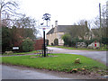 TF1005 : Ashton, Peterborough, village sign by Rodney Burton