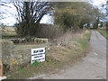 Milkchurn stand at road entrance to Dean Farm Oaksey