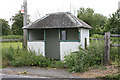 Forlorn bus shelter on A338 near railway bridge.