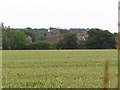 A view across an arable field to an Crockhurst Farm Oast , Tudeley.