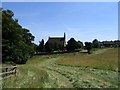 Hay field and Hollowell Church