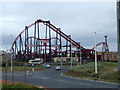 Rollercoaster beside a roundabout