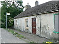 Abandoned cottage by the bus stop