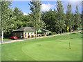 The 9th green at Melrose Golf Course with the clubhouse behind