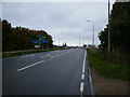 SP7554 : The A508 road approaching the M1 roundabout at junction 15 by Phil Catterall