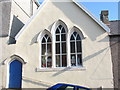 Dennis the Menace and Friends stare out of the windows of the old Catholic Church