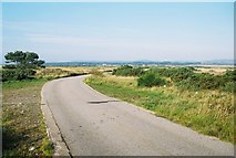 NH7988 : Road leading to Water Treatment Plant at Dornoch Links by Derek Brown