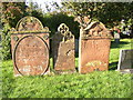 NY6127 : Gravestones in the church yard, Temple Sowerby by Humphrey Bolton