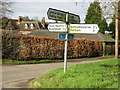 Bursted Manor and finger post at Pett Bottom.