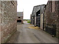 Tarmac track through farm buildings at Easter Wooden