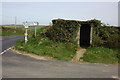 A bus shelter at a crossroads near Hersham