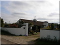 A fine weathervane on low buildings to the rear of Whixley Lodge