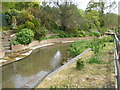 The River Dour appears tamed as it passes through Temple Ewell