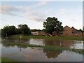 Flooded river Dearne with Little Houghton Millhouse in background