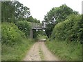 TF9235 : Pilgrim's Way bridges farm track by Nigel Jones