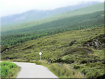 NC3956 : Road across moorland, towards forest by RH Dengate