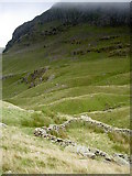 NY3612 : Sheepfold with Hutable Crag looming beyond by Ian Greig