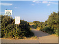 Path to beach with accompanying warnings.