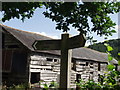 Timber barn and sign at Plas Dolanog