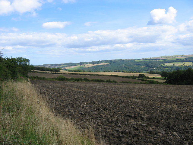 Freshly Ploughed Field Taken from the footpath which runs along the site of a disused railway. The dark foliage on the right of the picture is the edge of Spen Banks woodland.