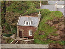 NJ8465 : House built against cliff, Pennan by David Hawgood