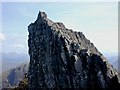 An impressive overhang indeed! The figure which can be seen to the right of the summit gives some idea of the scale of things, although the figure is on the higher main crest of Corrag Buidhe and over twice the distance away from the camera, for...