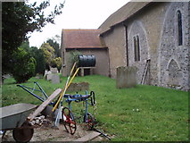 SU9503 : Farm implements in St Mary's churchyard, Barnham by Basher Eyre