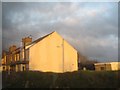 Houses in Mynytho lit up by the setting sun