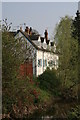 SO8963 : Houses by River Salwarpe by Chris Allen