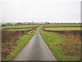 Road through hill farm pastures