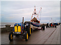 NZ6025 : Fishing boats and their tractors on Redcar seafront by Steve  Fareham