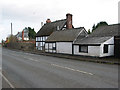 Half-timbered cottage and outbuildings