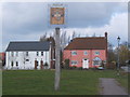 Village sign and houses by the green, Fordham