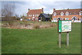 Village green with informative sign, Fordham