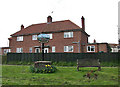 Red brick cottages and village sign