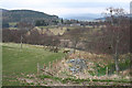 The chapel ruins and the chapel well are enclosed by the fence on the right