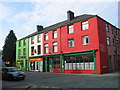 A block of shops in the High Street painted in the national colours of Wales