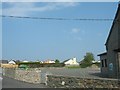 The  yard of Ysgol Bodffordd and an estate of bungalows