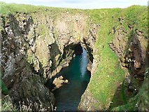 NK1038 : Arch through cliffs by James Allan