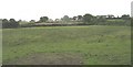 View across fields in the direction of the ribbon development along the B4422 Rhostrehwfa road