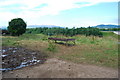 Cattle feeder and muddy puddle with Moffat Hills behind A74(M)