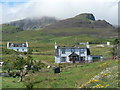 NG4667 : Staffin: scattered houses by Chris Downer