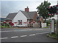 Manned level crossing at junction of two busy roads