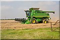 SU4737 : John Deere combine at work on West Stoke Farm by Peter Facey