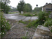 SS9187 : Road crossing disused railway by Roger