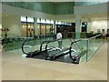 A hunter descends the escalator, Kings Place