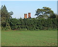 Chimneys beyond the hedge